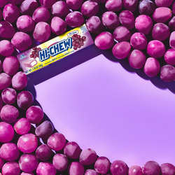 Hi-CHEW Grape Stick surrounded by grapes